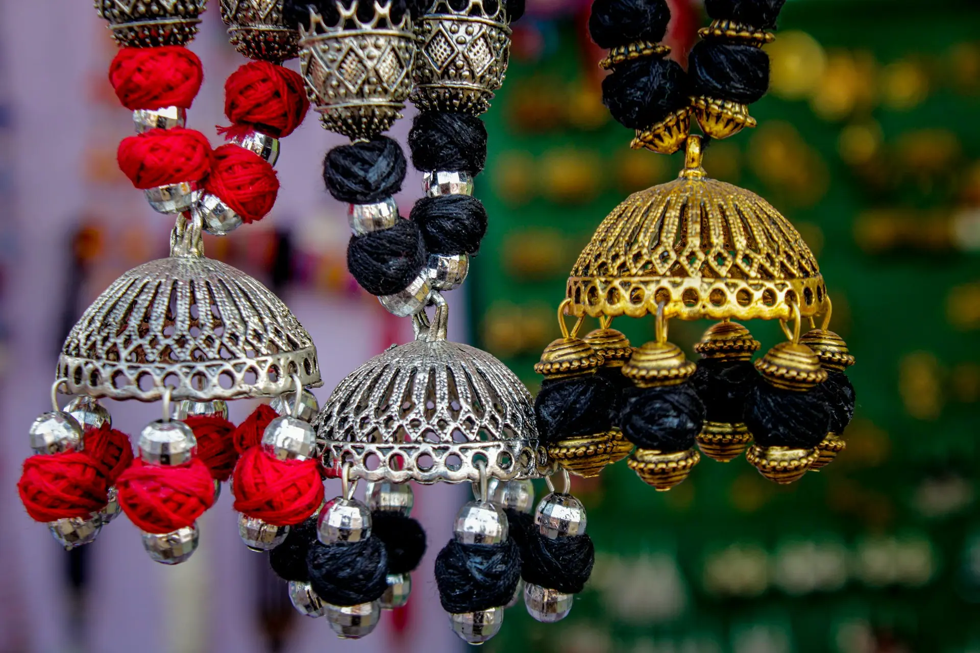 a close up of a bunch of bells hanging from a ceiling